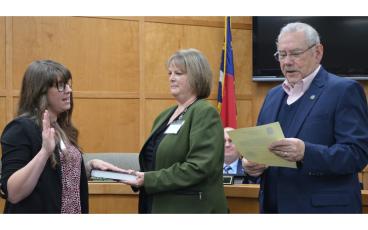 Press photo/Mia Overton Human Resources Director Nicole Bradley (left) was sworn in as Town Clerk during the Dec. 5 Franklin Town Council meeting. She will assume that role in addition to her human resources director duties. Bradley attended the UNC-SOG New Clerk’s Academy in November, which was the first step to her becoming a certified municipal clerk, and was the initial training needed to assume the full duties of the clerk. She is pictured with Town Manager Amie Owens and Mayor Jack Horton administerin
