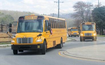 Press photo/Thomas Sherrill - Macon County school buses enter the roundabout at Depot Street on their way to Franklin High School for the afternoon pickup. 