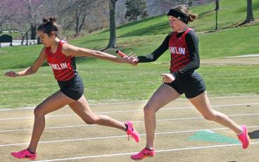 Press photo/Will Woolever - Panther standouts Laura Covarrubias (left) and Isabelle Duchemin exchange the baton at Rabun Gap March 18. 