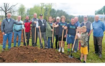 Press photo/Thomas Sherrill Town of Franklin, Macon County, Sk828 and other representatives, community members and youngsters all take part in a ceremonial groundbreaking of the Whitmire property skate park during a ceremony on Friday, April 14.