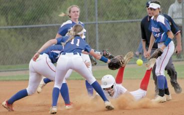 Press photo/Will Woolever Freshman center fielder Ashlynn McConnell slides back into second after being caught in a rundown versus Madison April 13.