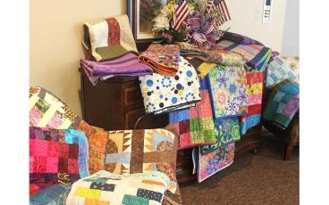 Press photo/Thomas Sherrill - Some of the quilts created by the Modern Quilt Guild for the 32 Union Academy graduates, displayed in the lobby of Holly Springs Baptist Church on Friday, May 26, where the graduation ceremony took place.
