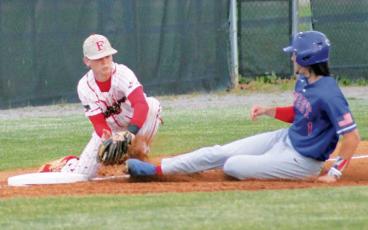 Press photo/Will Woolever - Junior third baseman Reed Raby tags a West Henderson base runner out at McConnell Field April 25. 