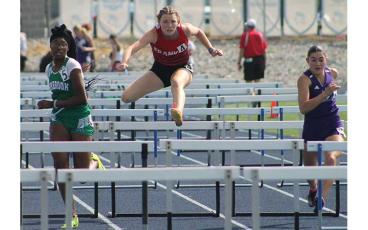 Press photo/Will Woolever - Senior Isabelle Duchemin competes in the 100-meter hurdles at the 3A West Regional meet May 12.