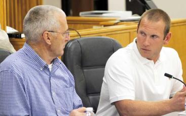 Press photo/Thomas Sherrill - Board of Commissioners Chair Paul Higdon and Commissioner Josh Young discuss the county’s 2023-24 budget during a special called meeting on June 19.