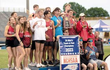 Photo courtesy of Clinton Taylor/Franklin Panther Sports Network - Panther athletes show off their men’s state title banner at the 3A State Track and Field Championships in Greensboro May 19. 