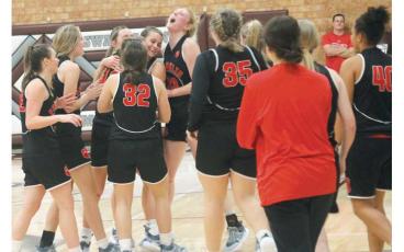 Senior Tori Ensley celebrates with teammates after recording her 1,001st career point at Swain Jan. 5.