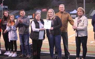 Press file photo - Lindsay Simpson receives her certificate of induction to the FHS Athletic Hall of Fame ahead of Panther football’s home game with West Henderson Oct. 21. 