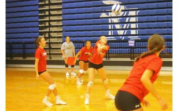 Press photo/Will Woolever - Freshman Dani Ledford sets a ball for her teammates in a preseason scrimmage July 26.