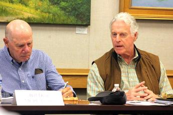 Press photo/Thomas Sherrill - Macon County Public Library Board of Trustees member Wood Lovell (right) makes a point to board chair Bill Dyar during the Oct. 3 meeting.