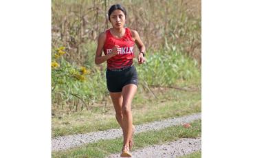 (Press file photo) Amy Mendoza Lopez nears the mile mark for Panther cross country at the Cherokee Mother Town near Ela Sept. 18. The sophomore broke a school record in the 3,200-meter run at the New Balance Dash for Doobie meet near Winston-Salem Nov. 18.