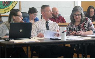 Press photo/Thomas Sherrill - Macon County Schools Finance Director Angie Cook (right) does some quick calculations with MCS Superintendent Josh Young and MCS Assistant Finance Director Alayna Ledford during the March 6 budget workshop.