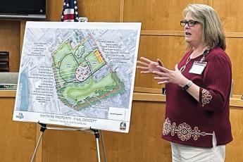 Press photo/Mia Overton - Franklin Town Manager Amie Owens reviews the plans for Phase 1 of the park on the Whitmire property during a public hearing on April 18. The town is applying for a $500,000 grant to help pay for installation of an inclusive playground.