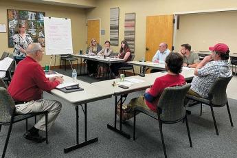 Press photo/Mia Overton Franklin Town Manager Amie Owens (standing), town administrative staff, Town Council members and Mayor Jack Horton discuss the proposed 2024-25 budget during a workshop on April 16 at Town Hall.