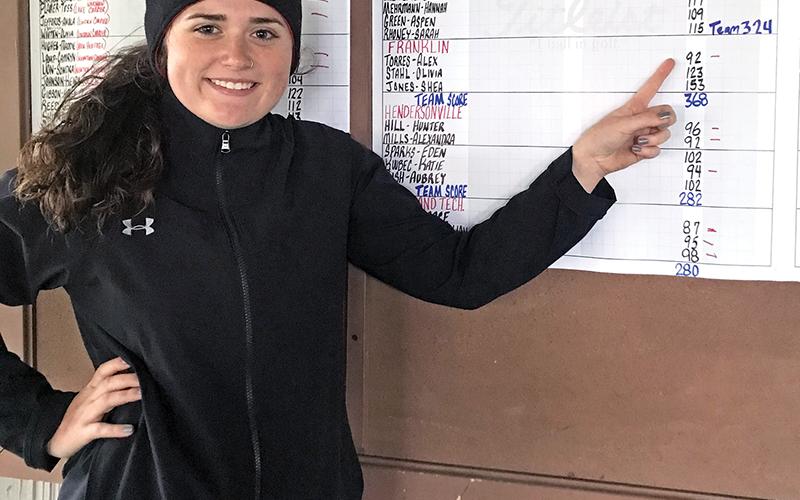 Photo submitted - Alex Torres points to her score of 92, shot in challenging and very difficult conditions Monday. She tied for 11th overall out of 62 golfers, who battled cold temps, thick fog and windy conditions at Mountain Glen Golf Club. This will be the Franklin senior’s third trip to the Pinehurst area for the state tournament. 