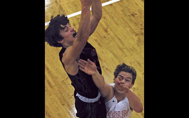 Press photo/Andy Scheidler Franklin sophomore Trey Penland rises high above a Rabun County player for a rebound. Penland scored 14 points in the road win, which saw the Panthers shoot above 50 percent for the second straight game.