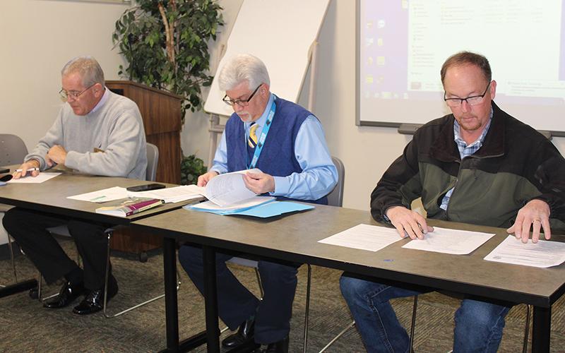 Press photo/Jake Browning Macon County commissioner Gary Shields, left, interim public health director Carmine Rocco and sheriff Robert Holland preside over an appeal on a ruling about a potentially dangerous dog.