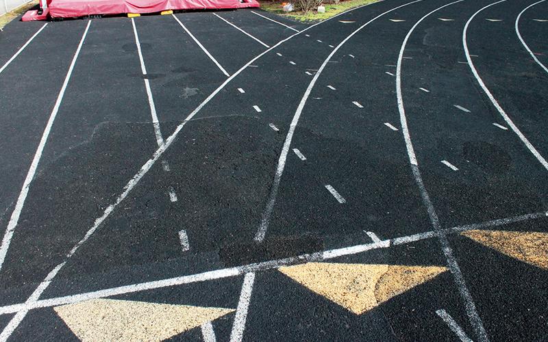 Press photo/Andy Scheidler - Large areas of the Franklin High School track have been repaired where bubbles formed because of poor drainage. However, repairs are no longer adequate to where FHS can host other teams to compete. 