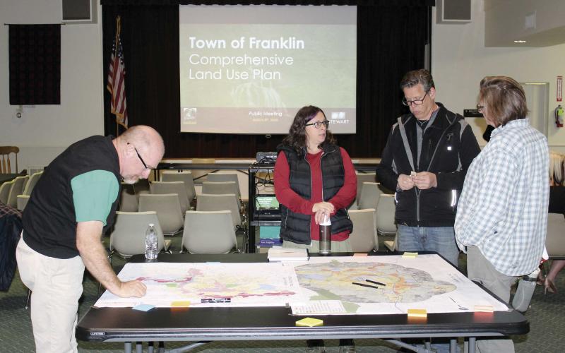Press photo/Jake Browning - Greg Mullins, Jen Seymour, Greg Seymour and Stacy Mullins review a town map at the comprehensive land use plan meeting.