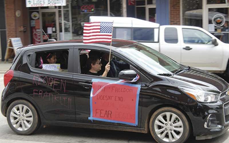 Press photo/Jake Browning - Several carloads of people rallied on Main Street in Franklin on Friday, April 24, calling for lifting coronavirus restrictions.