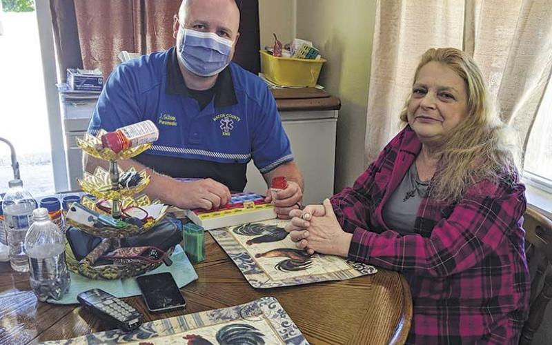 Photo submitted Joey Gibson, coordinator of the Community Care paramedic program, visits with Reba Wyatt.