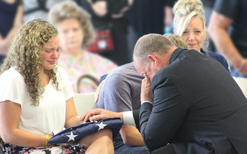Press photo/Jake Browning - Jeslyn Head, daughter of David Head, is presented with an American flag and Head’s service badge by sheriff Robert Holland during the service.