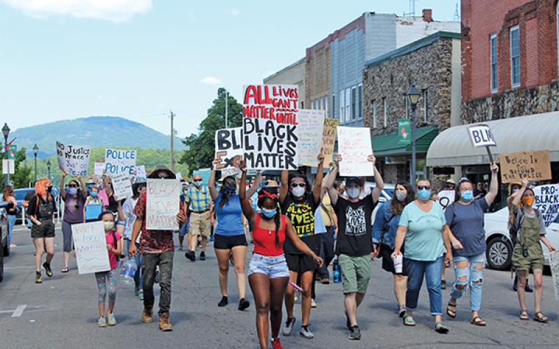 Press photos/Jake Browning - Participants make their way through downtown Franklin during a Peace March on Friday, June 12.