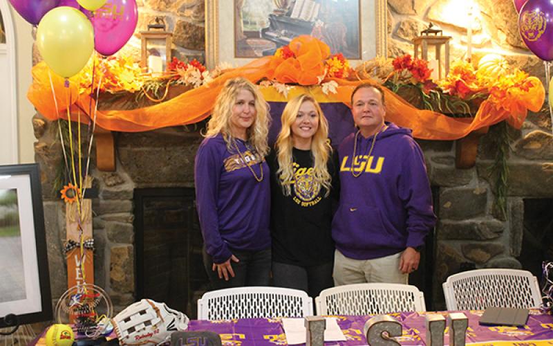 Press Photo/Will Woolever - Senior outfielder Mckenzie Redoutey stands with her mother, Deborah, and her father, Scott, after signing her official offer to LSU last week. Redouty will join a team with four Women’s College World Series berths in the past eight years.