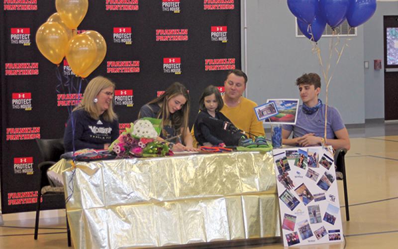 Press Photo/Will Woolever - FHS track and field standout Anna Tastinger signs her official offer from Montreat College as her mom, Julie; sister, Matilda; dad, John; and brother, John II look on.