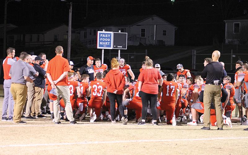 Press photo/Will Woolever - FHS head football coach Josh Brooks (center left) addresses his team following his last game, a home win against Smoky Mountain April 9.
