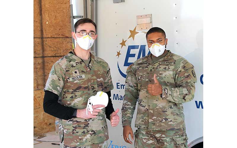 Press photo/Eric Braham- Specialist Ryan Nizolek and Staff Sgt. Hampton with the National Guard help distribute free N95 masks at the Macon County Health Department. Masks may be picked up in the drive-thru COVID testing lane in front of the jail on Lakeside Drive. To avoid wait times, do not go to pick up masks on Wednesdays when they are giving vaccines. To request a mask pick-up time, call 828-349-2081. 