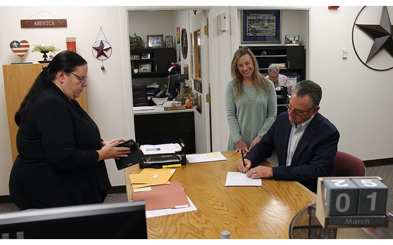 Press photo/Will Woolever Rep. Karl Gillespie files to run for re-election on Tuesday morning as his wife Janet and election specialist Judy Fritts look on.