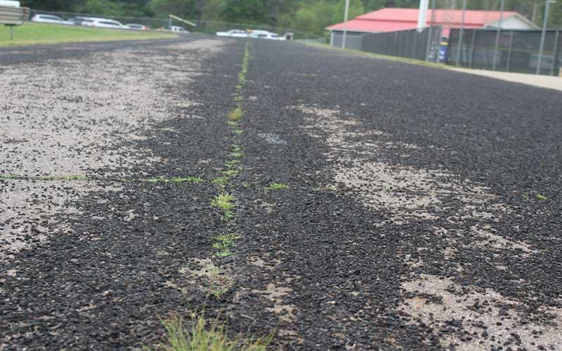 Press photo/Thomas Sherrill - The Macon Middle School track has been in a state of disrepair for several years, with the rubberized track surface eroding away.
