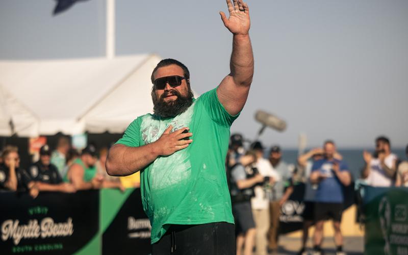 Photo courtesy of World’s Strongest Man/Todd Burandt.  Evans waves to the crowd after his standout performance in the log ladder. In the clean and press-style event, the Franklin native lifted five logs ranging from 275-400 lbs. over his head in less than 39 seconds for the best overall time in the competition.
