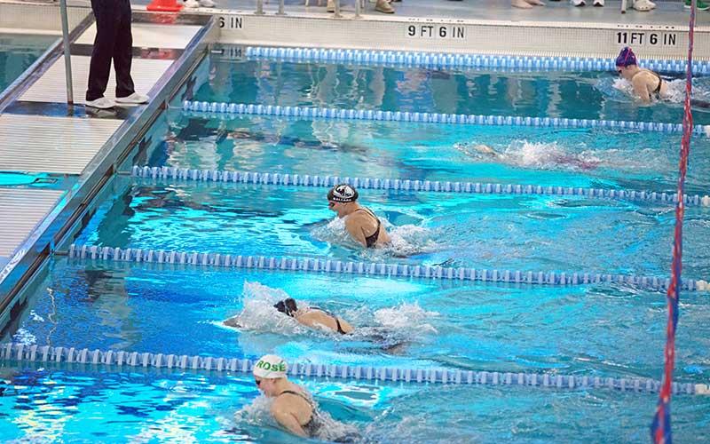 Senior Claire Ballard (top) competes in the 100-yard breaststroke at the 3A State Championship Feb. 8. She placed seventh overall and broke her own school record with a time of 1:10.92.
